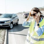 Woman calling during the road accident on the highway